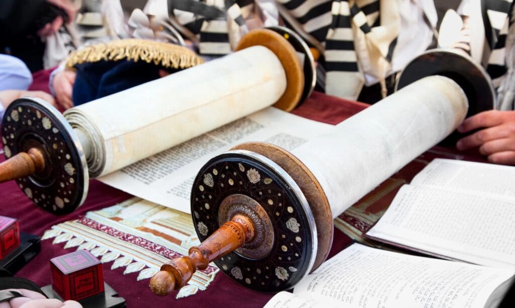 A torah scroll is sitting on top of the table.