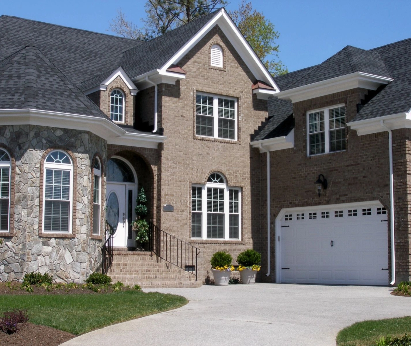 A large brick house with two garage doors.