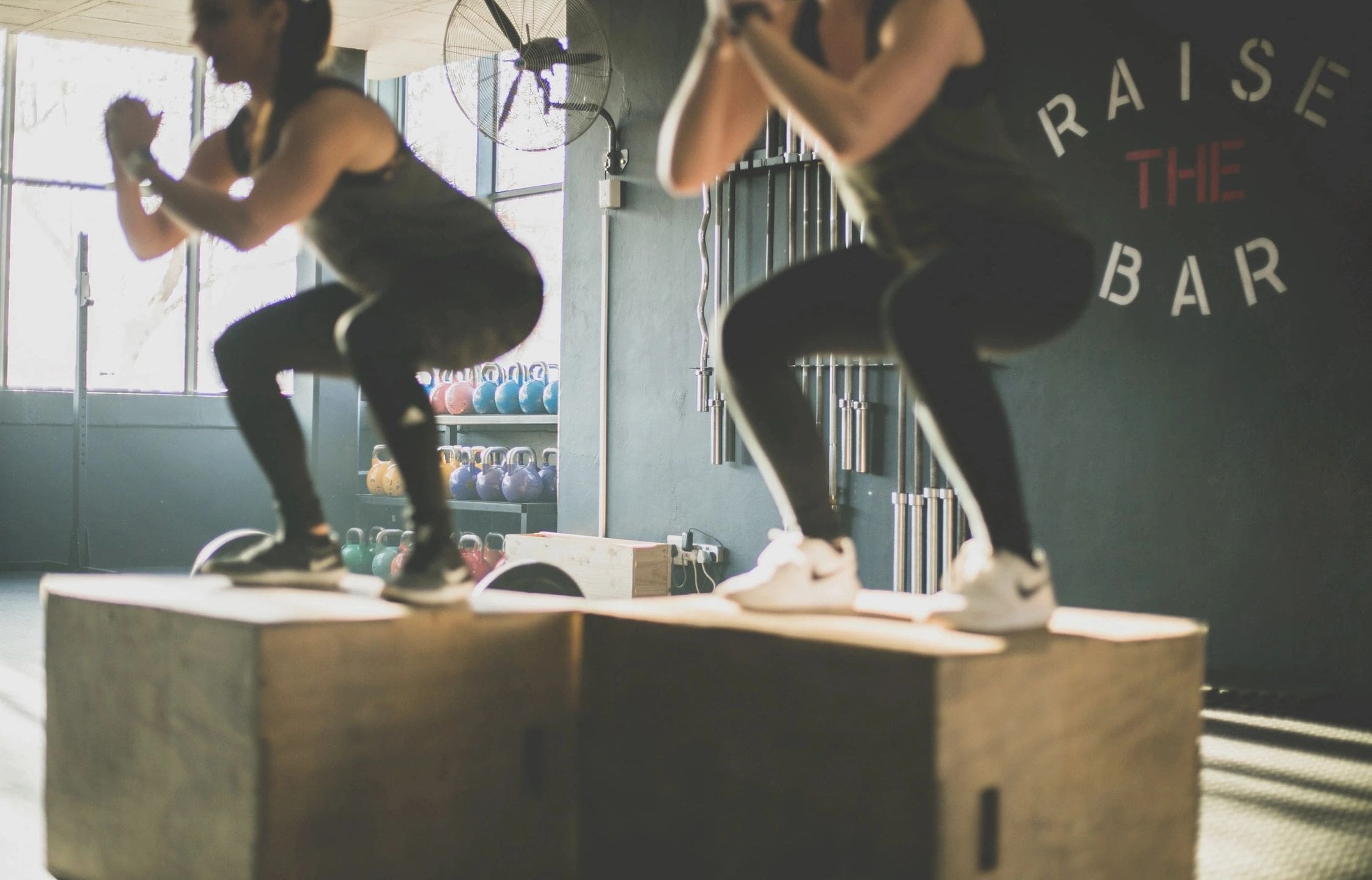 A woman is doing squats in the gym